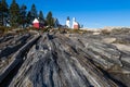 Pemaquid Point Lighthouse above rocky coastal rock formations on