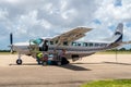 Pemba Domestic Airport apron with Auric Air local airline Cessna 208 Caravan aircraft loading baggage and preparing for flight. Royalty Free Stock Photo