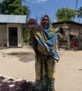 Pemba Island, Zanzibar, Tanzania - Kanuary 2020: Black Indigenous African People are walking around Pink seaweed - algae