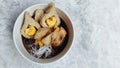 Pempek with vermicelli and cuko sauce on white bowl