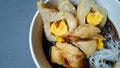 Pempek with vermicelli and cuko sauce on white bowl