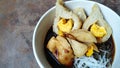 Pempek with vermicelli and cuko sauce on white bowl