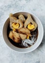 Pempek with vermicelli and cuko sauce on white bowl