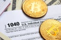 The pen, bitcoins and dollar bills is lies on the tax form 1040 U.S. Individual Income Tax Return. The time to pay taxes Royalty Free Stock Photo