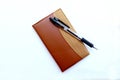 pen on brown notebook Royalty Free Stock Photo