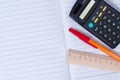 Pen, calculator and ruler on notebook Royalty Free Stock Photo