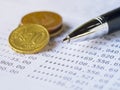 Pen and coins on Bank Account statement. Royalty Free Stock Photo