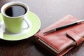 Pen on diary and coffee mug Royalty Free Stock Photo