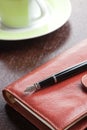 Pen on diary and coffee mug Royalty Free Stock Photo