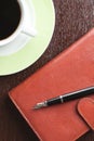 Pen on diary and coffee mug Royalty Free Stock Photo