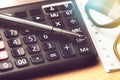 Pen and eyeglasses on number calculator button Royalty Free Stock Photo