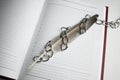 a pen fettered with chain on empty notepad. freedom of speech concept and journalism. copy space. world press freedom Royalty Free Stock Photo