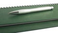 Pen on green spiral notepad