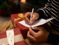 Pen, hands and man with card and gift for Christmas event or party at home for family. Celebration, paper and closeup of Royalty Free Stock Photo
