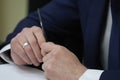 Pen in a man's hand, close up. The man signs the contract. Royalty Free Stock Photo