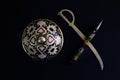 Pen is mightier than sword concept by decorated round sword shield and pen in black background .antique artefact