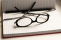 Pen note book and glasses on white Royalty Free Stock Photo