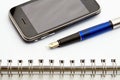 Pen, notebook and cell phone Royalty Free Stock Photo