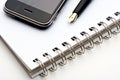 Pen, notebook and cell phone Royalty Free Stock Photo