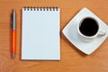 Pen, notebook and cup coffee on table. Royalty Free Stock Photo