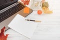 Pen, notebook, laptop, pumpkin, leaves, candle on a white table Royalty Free Stock Photo