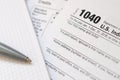 The pen and notebook is lies on the tax form 1040 U.S. Individual Income Tax Return. The time to pay taxes Royalty Free Stock Photo