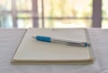 pen in notebook on office desk with blurry background Royalty Free Stock Photo