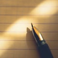 Pen on notebook paper in a line, macro photo Royalty Free Stock Photo