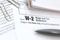 The pen and notebook on the tax form W-2 Wage and Tax Statement. The time to pay taxes Royalty Free Stock Photo