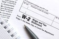 The pen and notebook on the tax form W-2 Wage and Tax Statement. The time to pay taxes Royalty Free Stock Photo