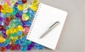 Notepad and pen with gems on gray background Royalty Free Stock Photo