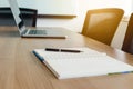 Pen on notepad and laptop and for agenda kept on table in empty corporate conference room. Royalty Free Stock Photo