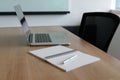 Pen on notepad and laptop and for agenda kept on table in empty corporate conference room. Royalty Free Stock Photo