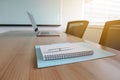 Pen on notepad and laptop and for agenda kept on table in empty corporate conference room. Royalty Free Stock Photo