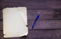 Pen with old paper on wooden background Royalty Free Stock Photo