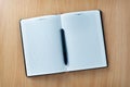 Pen on an open agenda or notebook with blank pages Royalty Free Stock Photo