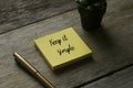 Pen, plant and yellow sticky notes written with Keep it simple on wooden background Royalty Free Stock Photo