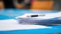 Pen resting on a stack of paper documents close up Royalty Free Stock Photo