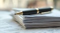 A pen resting on top of a stack of papers, great for office or desk use Royalty Free Stock Photo