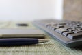 pen, smartphone and keyboard on table close up Royalty Free Stock Photo