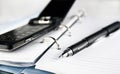 Pen, spiral notebook and cell phone Royalty Free Stock Photo