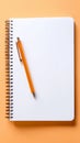 A pen and a spiral notebook are placed on a table Royalty Free Stock Photo