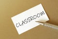 Pen, white paper with text Classroom on the brown background Royalty Free Stock Photo