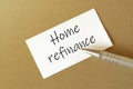 Pen, white paper with text Home refinance on the brown background