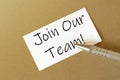 Pen, white paper with text Join Our Team on the brown background Royalty Free Stock Photo