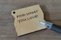 Pen and wooden board written with FIND WHAT YOU LOVE Royalty Free Stock Photo