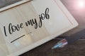 Pen and wooden board written with text I LOVE MY JOB. Selective focus Royalty Free Stock Photo