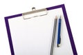Pen and wooden pencil on clipboard closeup Royalty Free Stock Photo
