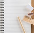 Pen, wooden ruler, pencil sharpener and white eraser set on diary page.