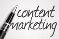 Pen writes content marketing on paper Royalty Free Stock Photo